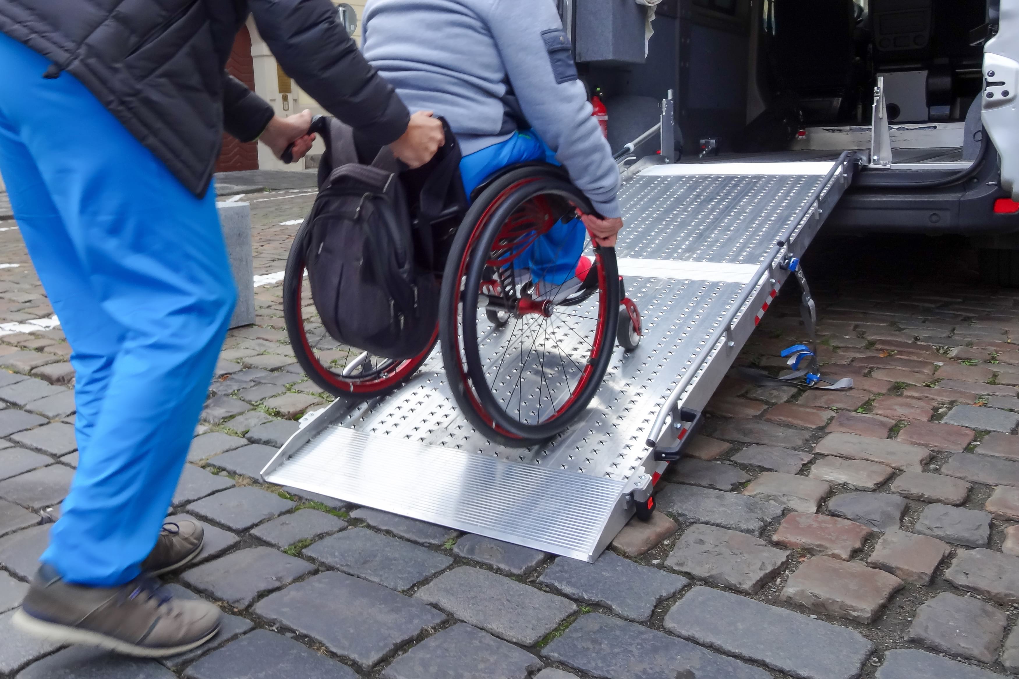 Person in wheelchair loading onto van