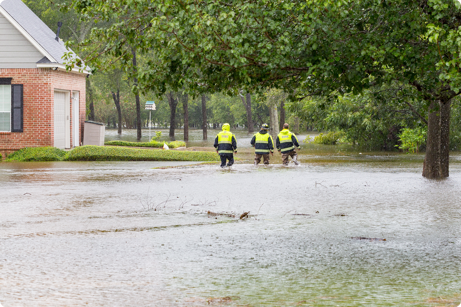 First responders wade through floodwaters