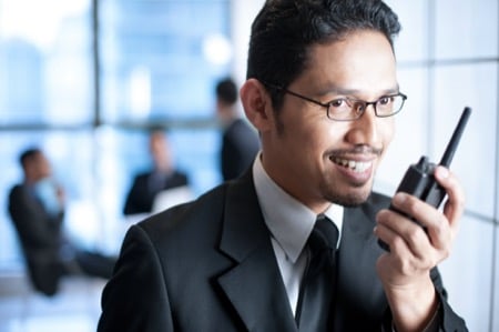 Man speaking into a walkie talkie